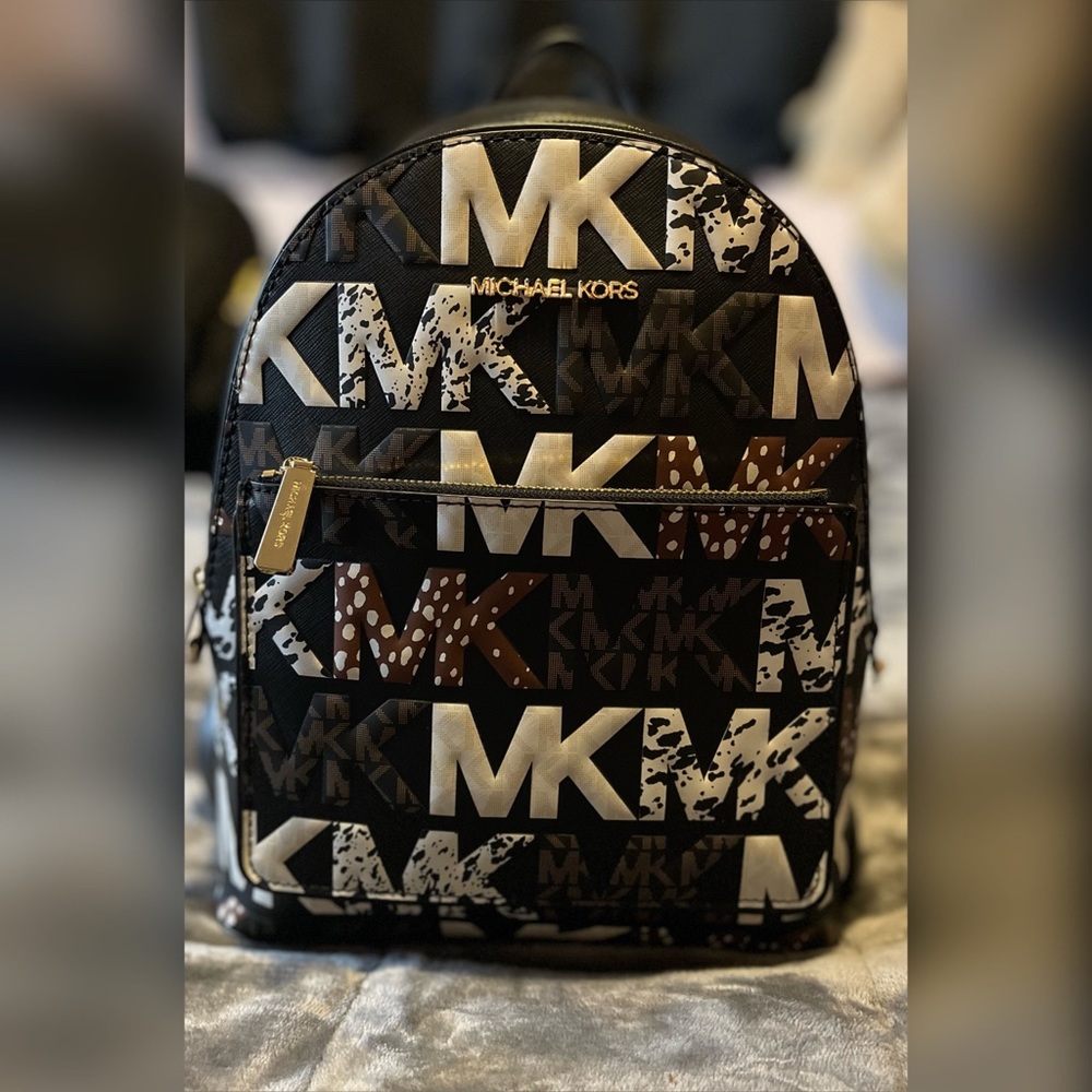 BNWT MK multi signature pattern mini backpack.